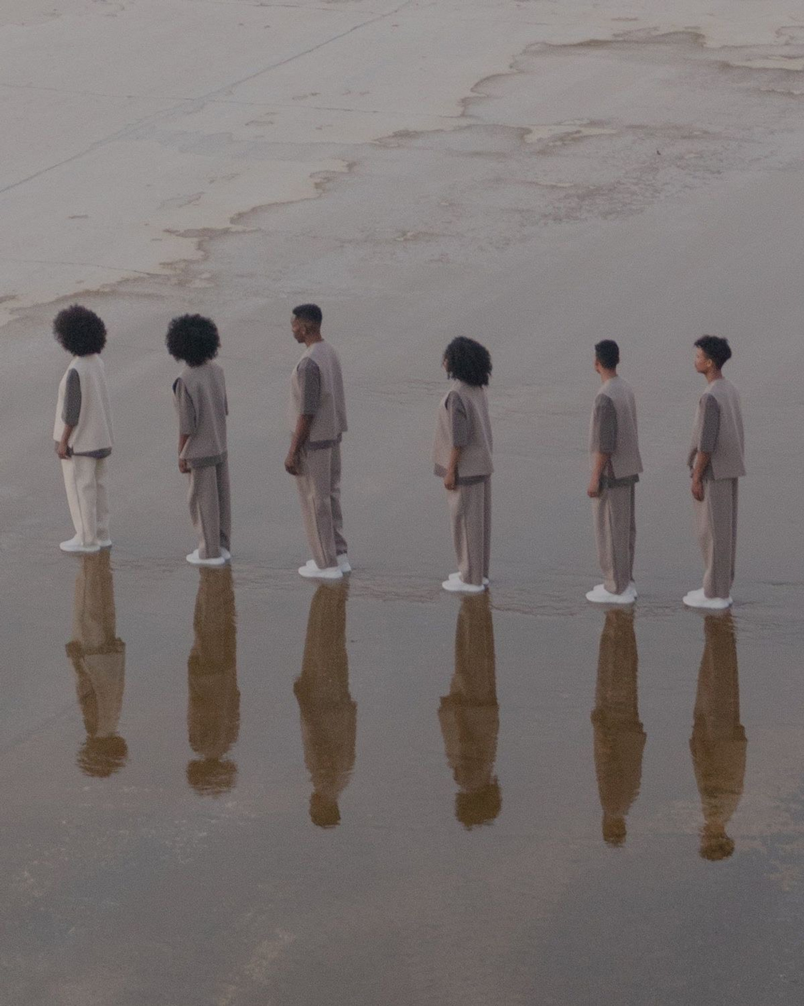 Figures standing on tidal flat
